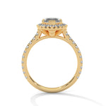 Gold ring with a large central diamond and smaller diamonds around on a white background 