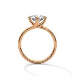 Rose gold ring with a large diamond on a white background 