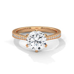 Rose gold ring with a large diamond on a white background 