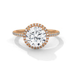 Rose gold ring with a large diamond on a white background 