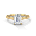 Gold ring with a large diamond on a white background 