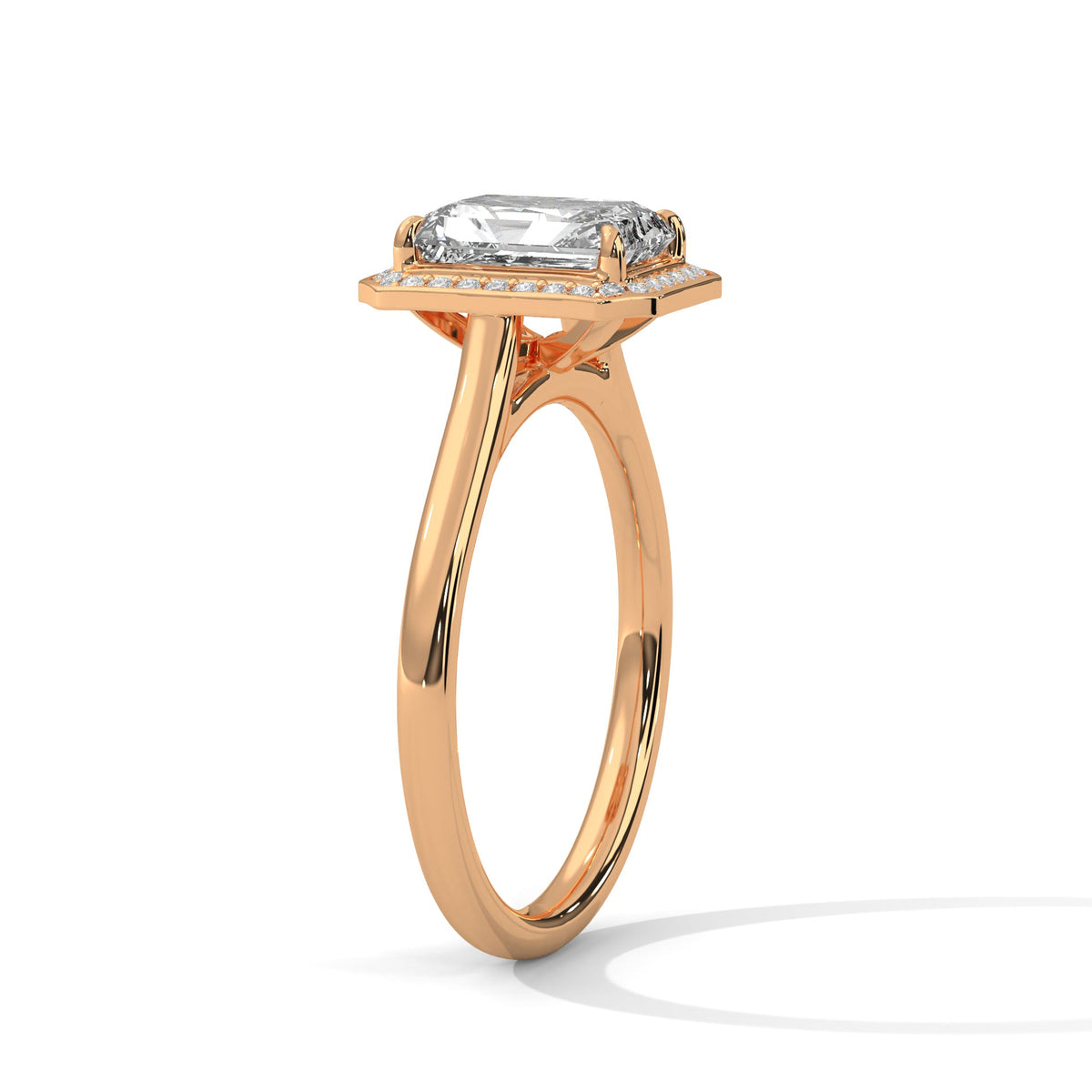 Rose gold ring with a large diamond on a white background 