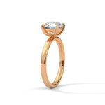 Rose gold ring with a large diamond on a white background 