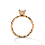 Rose gold ring with a large diamond on a white background 
