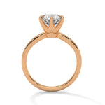 Rose gold ring with a large diamond on a white background 