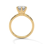 Gold ring with a large diamond on a white background 