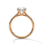 Rose gold ring with a large diamond on a white background 