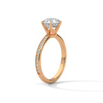 Rose gold ring with a large diamond on a white background 
