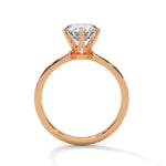 Rose gold ring with a large diamond on a white background 