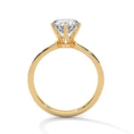 Gold ring with a large diamond on a white background 