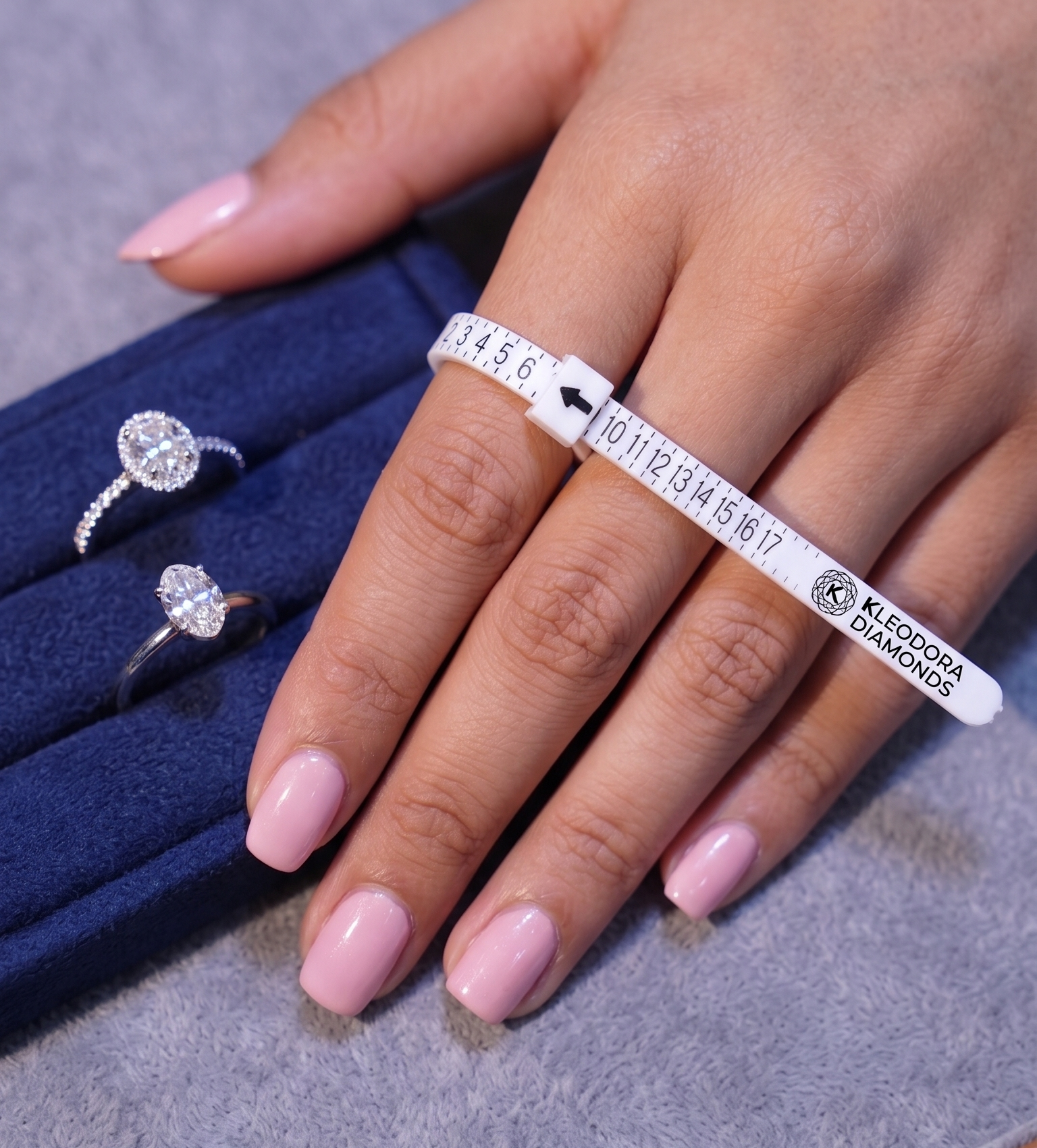 Womans Hand with a ring sizer with print kleodora diamons with diamond rings in atelier