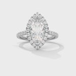 Diamond ring with a marquise-shaped center stone on a white background 