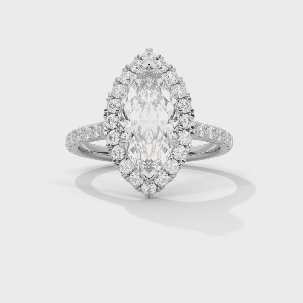 Diamond ring with a marquise-shaped center stone on a white background #white-gold