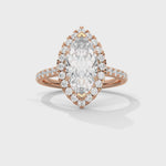 Rose gold ring with a large diamond and smaller diamonds on a white background 